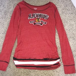 A red over all base on a long sleeve shirt